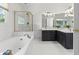 This primary bathroom features a soaking tub, glass shower, and double vanity at 3595 Evonvale Overlook, Cumming, GA 30041