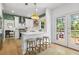 Bright kitchen featuring white cabinets, stainless steel appliances, and a cozy breakfast bar at 3595 Evonvale Overlook, Cumming, GA 30041