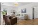 Bright living room with hardwood floors, fireplace, comfortable seating, and backyard views at 3595 Evonvale Overlook, Cumming, GA 30041