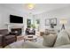 Sunlit living room boasts a fireplace, stylish seating, and decor accents at 3595 Evonvale Overlook, Cumming, GA 30041