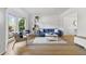 Bright living room with large windows, hardwood floors and comfortable seating at 3595 Evonvale Overlook, Cumming, GA 30041