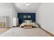 The main bedroom features a sloped ceiling and a plush rug over hardwood floors at 3595 Evonvale Overlook, Cumming, GA 30041