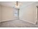 Clean, neutral bedroom with a ceiling fan, carpet, and a view from one window at 100 Hamilton Glen Ct, Fayetteville, GA 30215