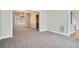 The spacious, carpeted dining room features elegant chandelier and large window for natural light at 100 Hamilton Glen Ct, Fayetteville, GA 30215