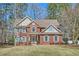 Charming two-story brick home with a manicured lawn and blue shutters gives a welcoming curb appeal at 100 Hamilton Glen Ct, Fayetteville, GA 30215