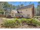 Rear exterior view of home with a small deck and lush greenery at 100 Hamilton Glen Ct, Fayetteville, GA 30215