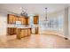 Open kitchen with tile flooring, wooden cabinets, island, and bay window at 100 Hamilton Glen Ct, Fayetteville, GA 30215