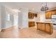 Bright eat-in kitchen featuring tile floors, wooden cabinets, island, and white appliances at 100 Hamilton Glen Ct, Fayetteville, GA 30215