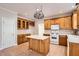 Bright eat-in kitchen with an island, white appliances, and custom cabinets at 100 Hamilton Glen Ct, Fayetteville, GA 30215