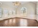 Bright living room features hardwood floors, a fireplace, and large windows at 100 Hamilton Glen Ct, Fayetteville, GA 30215