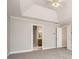 Carpeted main bedroom with trey ceiling, adjacent bathroom, and two closets at 100 Hamilton Glen Ct, Fayetteville, GA 30215