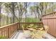 Outdoor back deck with nature views and wrought-iron furniture at 1111 Newpark View Pl, Mableton, GA 30126