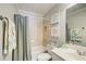 Well-lit bathroom with a shower-tub combo, single sink vanity and framed prints at 1111 Newpark View Pl, Mableton, GA 30126