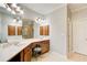 Bathroom vanity with double sinks, stylish lighting, and wood cabinets at 1111 Newpark View Pl, Mableton, GA 30126