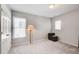 A gray bedroom with ample natural light, carpet floors, closet, and floor lamp at 1111 Newpark View Pl, Mableton, GA 30126