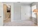 A gray bedroom with ample closet space, neutral carpet, and a view of an adjacent room at 1111 Newpark View Pl, Mableton, GA 30126
