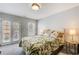 Bedroom featuring bright, natural lighting from the windows and a comfy bed with botanical pattern bedding at 1111 Newpark View Pl, Mableton, GA 30126