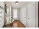 Foyer with hardwood flooring, decorative table and decor, and sunlit window with shutters at 1111 Newpark View Pl, Mableton, GA 30126