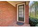 Stylish front door with glass panels, set in a brick facade at 1111 Newpark View Pl, Mableton, GA 30126