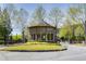 Neighborhood entry gazebo with glass windows, flower beds, and surrounding green space at 1111 Newpark View Pl, Mableton, GA 30126