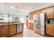 A kitchen boasts wood cabinets, stainless steel appliances, granite counters, and natural light at 1111 Newpark View Pl, Mableton, GA 30126
