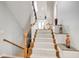 Staircase with carpeted steps, wooden handrail, and decorative accents at 1111 Newpark View Pl, Mableton, GA 30126
