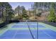 Tennis courts surrounded by trees in the community at 1111 Newpark View Pl, Mableton, GA 30126