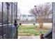 View of the backyard showing the tennis court and neighboring houses through the door at 11169 James Madison Dr, Hampton, GA 30228