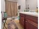 Bathroom featuring a toilet, sink, and vanity with a patterned shower curtain at 11169 James Madison Dr, Hampton, GA 30228