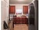 Kitchen featuring a window over the sink with dark cabinets and a stainless-steel fridge at 11169 James Madison Dr, Hampton, GA 30228