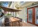 Charming outdoor deck featuring a wooden table, chairs, and a patio umbrella at 484 Martin Se St, Atlanta, GA 30312