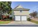 Two-car garage with white doors at end of driveway and building's exterior at 484 Martin Se St, Atlanta, GA 30312
