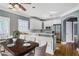 Bright kitchen area boasts white cabinetry, stainless steel appliances, and a breakfast bar with seating at 484 Martin Se St, Atlanta, GA 30312