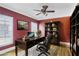 This office features a ceiling fan, hardwood floors, and a dark wood desk with built-in shelving at 484 Martin Se St, Atlanta, GA 30312