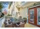 Outdoor patio featuring wicker furniture, a glass table, and potted plants, perfect for outdoor dining at 484 Martin Se St, Atlanta, GA 30312