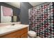 Cozy bathroom with a gray wall and a shower featuring a patterned curtain at 665 Sable View Ln, Atlanta, GA 30349