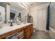 Well-lit bathroom featuring a double sink vanity and shower-tub combo at 665 Sable View Ln, Atlanta, GA 30349