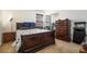 Bedroom with a window, dark wood furniture, and carpeted floors at 665 Sable View Ln, Atlanta, GA 30349