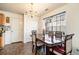 Inviting dining area featuring a chandelier, large windows, and seating for four at 665 Sable View Ln, Atlanta, GA 30349