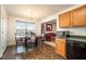 Charming dining area with a chandelier, large windows, and adjacent kitchen appliances at 665 Sable View Ln, Atlanta, GA 30349