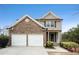 Charming two-story home featuring a stacked stone front and a two car garage at 665 Sable View Ln, Atlanta, GA 30349