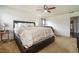 Large, carpeted primary bedroom with ceiling fan and furniture at 665 Sable View Ln, Atlanta, GA 30349