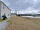 View of the backyard with a partial view of the house and lake at 6716 Browns Mill Ferry Dr, Lithonia, GA 30038