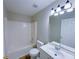 Bathroom featuring a white bathtub, toilet, vanity with sink, and a large mirror at 6716 Browns Mill Ferry Dr, Lithonia, GA 30038