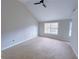 Bedroom features a vaulted ceiling, neutral carpet, and natural light through the large windows at 6716 Browns Mill Ferry Dr, Lithonia, GA 30038