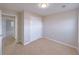 Clean bedroom with neutral carpet and paint, closet, and view to another room at 6716 Browns Mill Ferry Dr, Lithonia, GA 30038