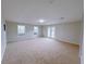 Expansive bonus room with neutral carpet, natural light from windows and french doors to outdoors at 6716 Browns Mill Ferry Dr, Lithonia, GA 30038