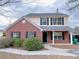 Charming two-story home featuring a brick facade, covered entryway, and well-maintained landscaping at 6716 Browns Mill Ferry Dr, Lithonia, GA 30038