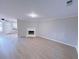 Spacious living room featuring a fireplace, light-colored walls, and wood-look flooring at 6716 Browns Mill Ferry Dr, Lithonia, GA 30038