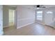 Bright room with ceiling fan, fresh paint, leading to a bathroom and front door at 6716 Browns Mill Ferry Dr, Lithonia, GA 30038